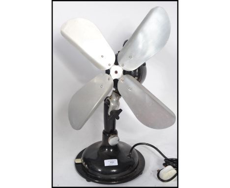 A vintage retro 20th century industrial desk top fan. The ebonised fan having steel fan blades. Makers plaque reading Raj Kum