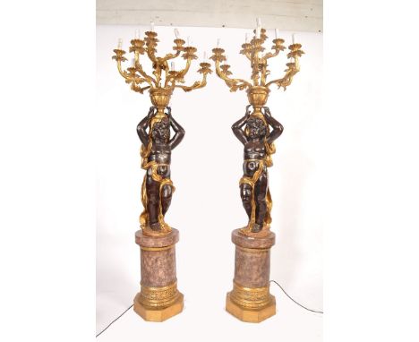 A decorative pair of 20th century large Venetian style Blackamoor floor standing standard lamps.&nbsp;Each painted and gilt-h