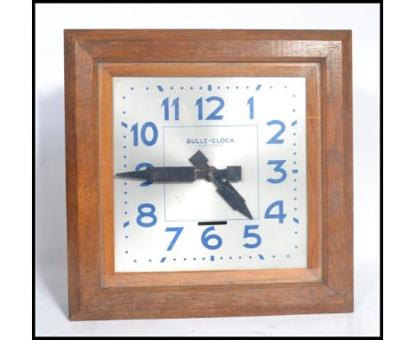 A vintage early 20th century French Art Deco Bulle Electrique Oak Wall Clock, with 15 1/2 in. square case with top hinged bez