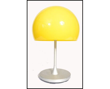 After Verner Panton - Flowerpot - A 20th century table lamp having a domed vibrant yellow plastic shade sat on top of a matt 