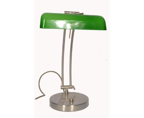 A 20th century retro bankers lamp having a brushed metal twin sweeping arm attached&nbsp;to a terraced base with a wide green