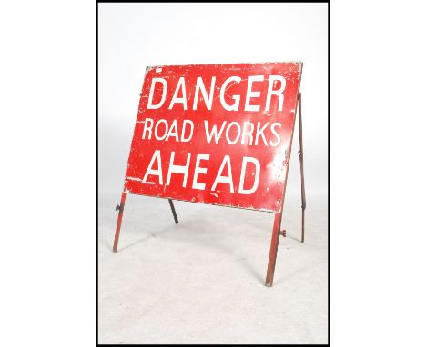 A 1960's enamel Industrial road sign. The red painted sign with red ground and white notation for ' Danger Road Works Ahead '