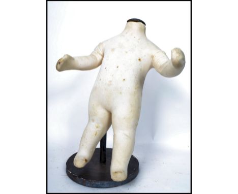 An unusual 20th century&nbsp; Industrial shop haberdashery child's - baby mannequin. The body in white fabric being raised on