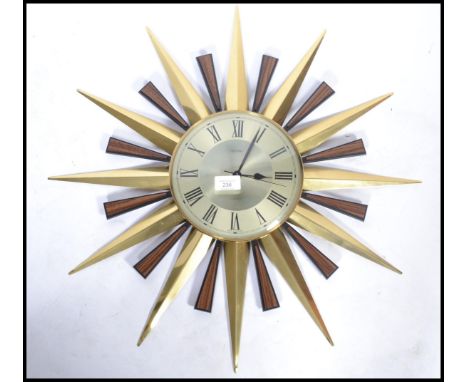 A vintage 20th century Metamec sun burst star burst wall clock having a Roman numeral chapter ring with faceted hands. 60cm i