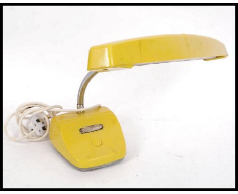 A 1960's Italian vivid yellow believed Italian goose neck desk lamp having adjustable chrome neck with block plinth base and 