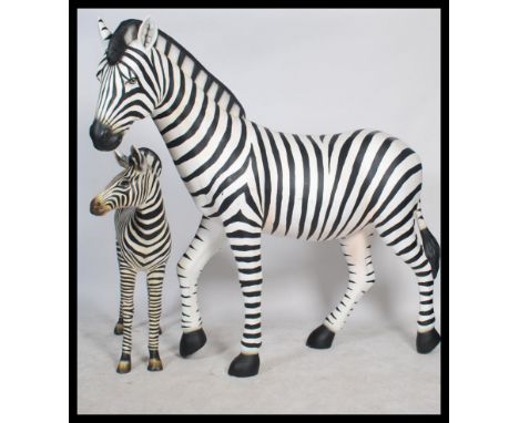 A stunning life-size resin painted grand scale adult female Zebra sculpture together with a Zebra foal sculpture. The paintwo