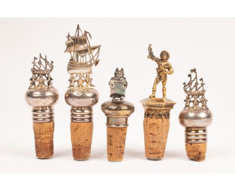 Three Continental silver mounted bottle stoppers, early 20th Century, decorated with cherubs and ships, marked 925, a silver 