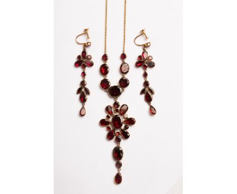 A Georgian style garnet pendant necklace, set with oval, round and pear shape stones in a closed back settings, on a later ch