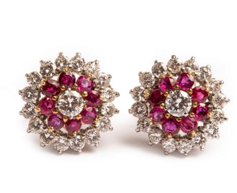 A pair of early 20th Century diamond and ruby target cluster earrings, each set with a central round cut diamond, approximate