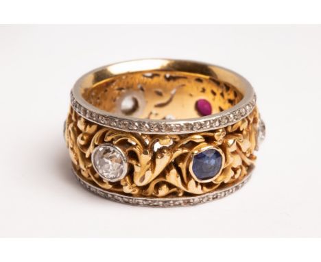 A late 19th Century French gold and multi gem-set ring, the central yellow metal band with pierced foliate scrolls, set with 