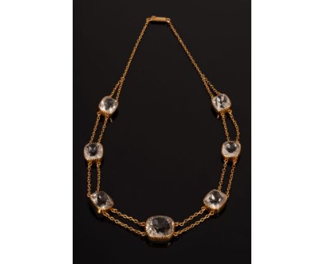 An Edwardian rock crystal necklace, set with seven graduated cushion cut stones, the largest approximately 15mm x 14mm x 9mm,