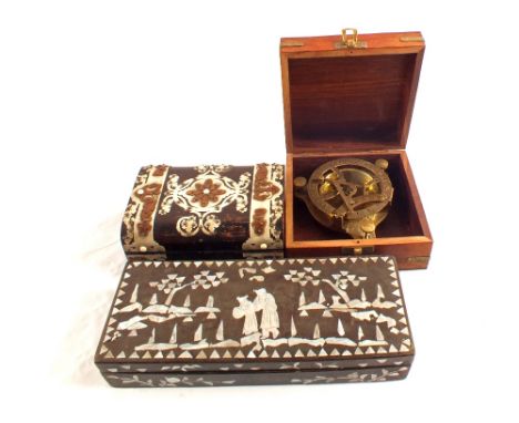 Three boxes, one with compass