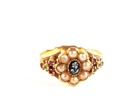 A Gold memorial ring set with Seed Pearls in flower form, centre set with black stone inlaid flower detail, shoulders set wit