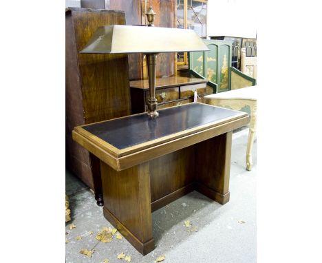 LIBRARY READING TABLE, mid 20th century, walnut, green tooled hide slab support and numbered brass double reading lamp, 121cm