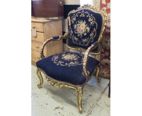 FAUTEUILS, a pair Louis XV design with blue tapestry style upholstery in a gilded frame.