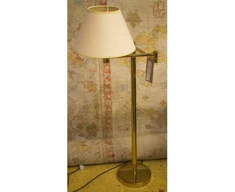 READING LAMP, brass with a cream shade, similar to the previous lot, 118cm H.