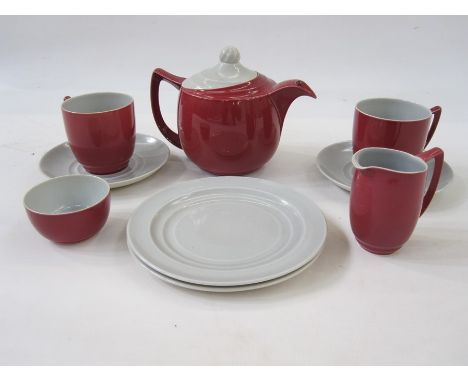 Branksome China, England tete a tete comprising of teapot, milk jug, sugar bowl, two cups, saucers and teaplates, in maroon w