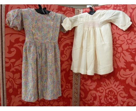 Child's silk dress with Liberty-style print, with frilled front, pockets and tie back and three silk smocked dresses (4) 