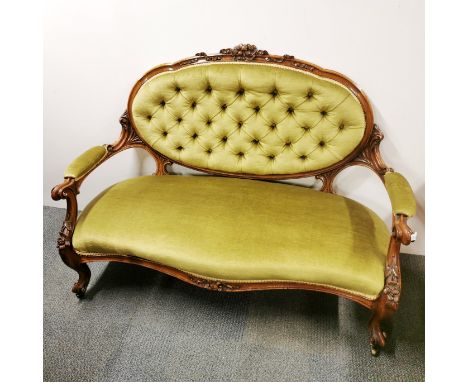 A Victorian carved walnut button backed two seater settee, L. 135cm D. 65cm.