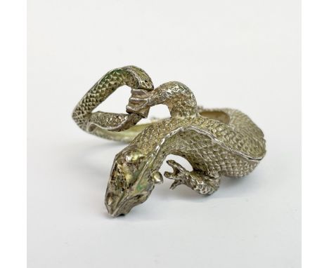 An Oriental white metal (tested silver) dragon shaped bangle, L. 5.5cm.
