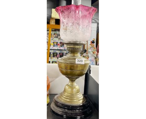 A Victorian brass oil lamp and shade, H. 53cm.
