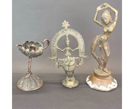 An Indian bronze figure of a dancing deity, H. 28cm together with a further bronze figure and a copper bronze candle holder. 