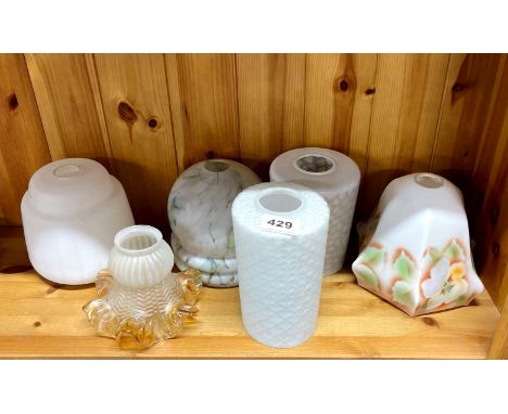 A group of vintage glass light shades.