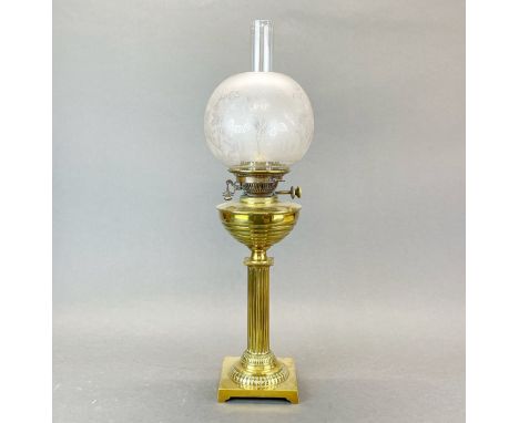A brass column oil lamp and shade, H. 62cm.