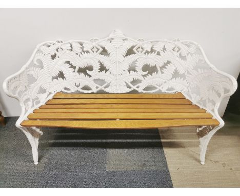 A matching white finished cast iron garden bench with light wood panels, 155 x 90 x 55cm.