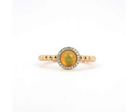 A 14ct rose gold (stamped 585) cluster ring set with a cabochon cut fire opal and diamonds, ring size N.