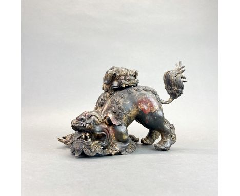 A Chinese gilt bronze figure of two lion dogs playing, H. 21cm W. 32cm.