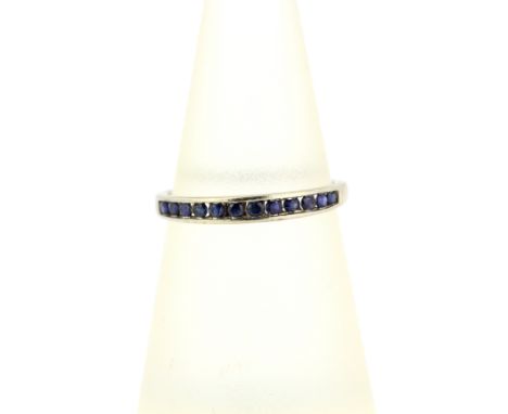 A 9ct white gold sapphire set half eternity ring, ring size L.5.