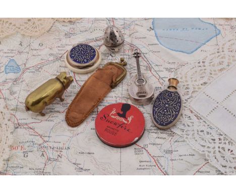 A novelty brass standing pig lipstick, 5cm, a 925 marked novelty hinged lid guitar pendant compact, 6cm, a matching cobalt bl