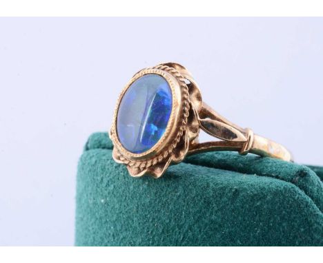 A 9ct gold black opal dress ring, the cabochon in scroll setting, ring size P, 2.7g, boxed