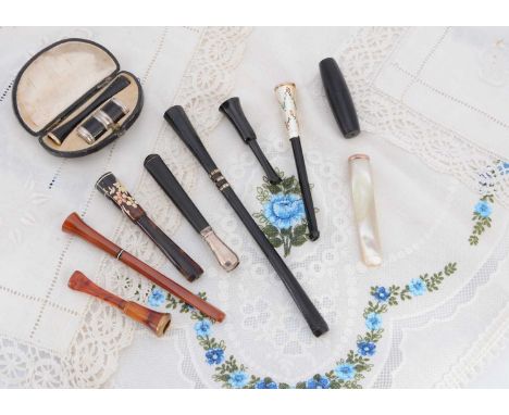 Cheroot holders, including plastic examples, silver mounted, gold mounted, cased example with barrel lighter and telescopic e