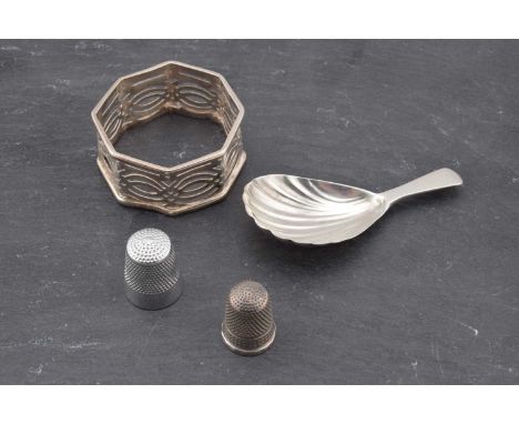 A George III silver oyster caddy spoon, London 1803, 7.5cm, a silver sewing thimble, Chester 1913, Charles Horner, 2cm and an