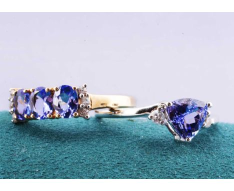 A three stone tanzanite and cubic zirconia 9ct gold dress ring, together with a white 9ct gold tanzanite dress ring, both rin