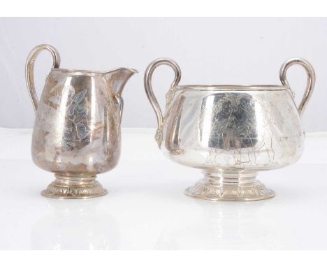 An early 20th century Swedish milk jug and twin handled sugar basin, 13 ozt, each with engraved decoration of cherubs (2)