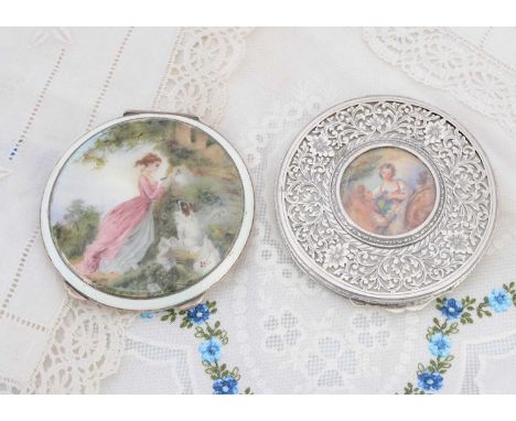 Two circular silver compacts, the pierced floral and fern border example having central portrait of females in landscape, fer