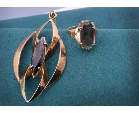 A 9ct gold smoky quartz necklace and matching ring, the pendant set with multi elliptical rings, supported on a fine curb lin