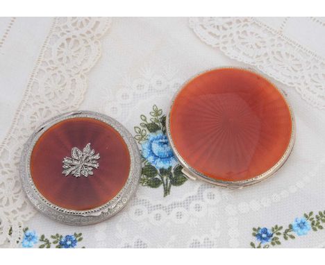 Two circular silver compacts both with burnt orange guilloche enamel, Birmingham 1957 with engine turned decoration verso, 7c