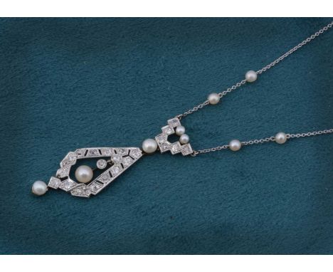 A platinum and white gold art deco pendant on later chain, the pendant of architectural pierced design with central suspended