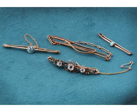 A collection of three yellow metal brooches, set with zircon, opal and paste and a 9ct gold and chain link tie slide, 15.8g