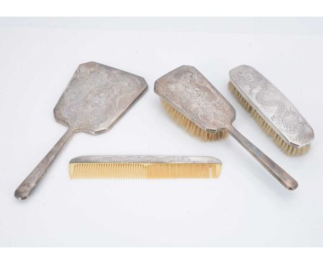 An Art Deco period Hong Kong four piece dressing table set by Tack Hing, hair and clothes brush, comb and mirror, each marked