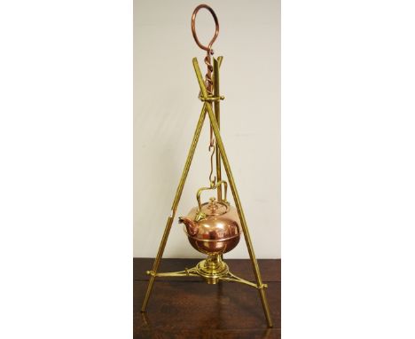 An Arts and Crafts copper and brass spirit kettle, stand and burner, in the manner of W A S Benson, the tripod stand with pos