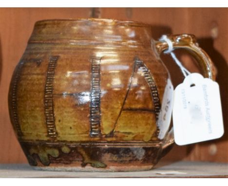 A Wenford Bridge ribbed ovoid mug, by Seth Cardew, slip glazed in mottled brown, sgraffito incised with the name Martha in ta