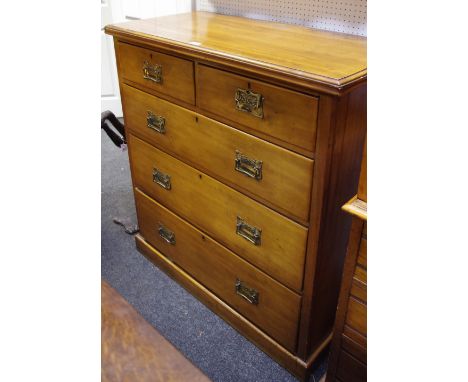 A Victorian satinwood chest of short above three long drawers, oversized Art Nouveau copper escutcheons with stylized drop ha