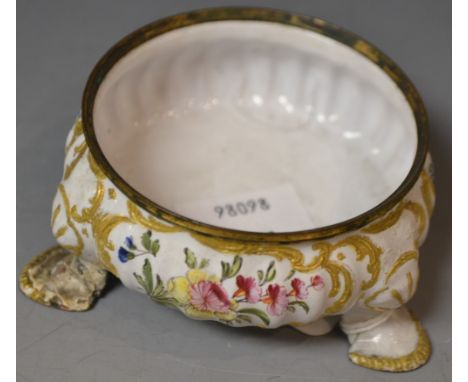 A George III Battersea enamel cauldron salt, painted with reserves of country flowers in scrolling leafy borders of raised gi