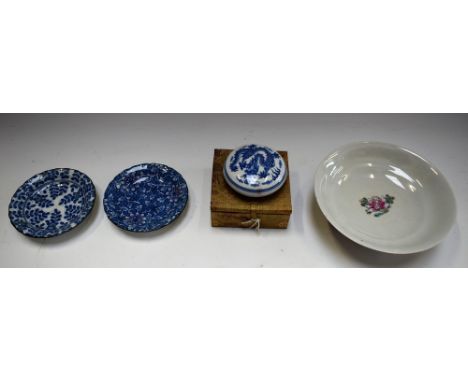 A Cantonese footed bowl, decorated with flowers and foliage on a green ground; a blue and white circular box and cover with d