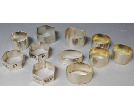 A quantity of silver and white metal napkin rings, including engine turned, engraved, etc (11)